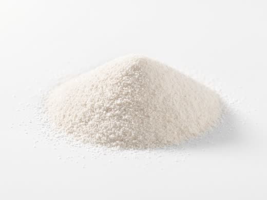 A mound of fine white magnesium citrate powder