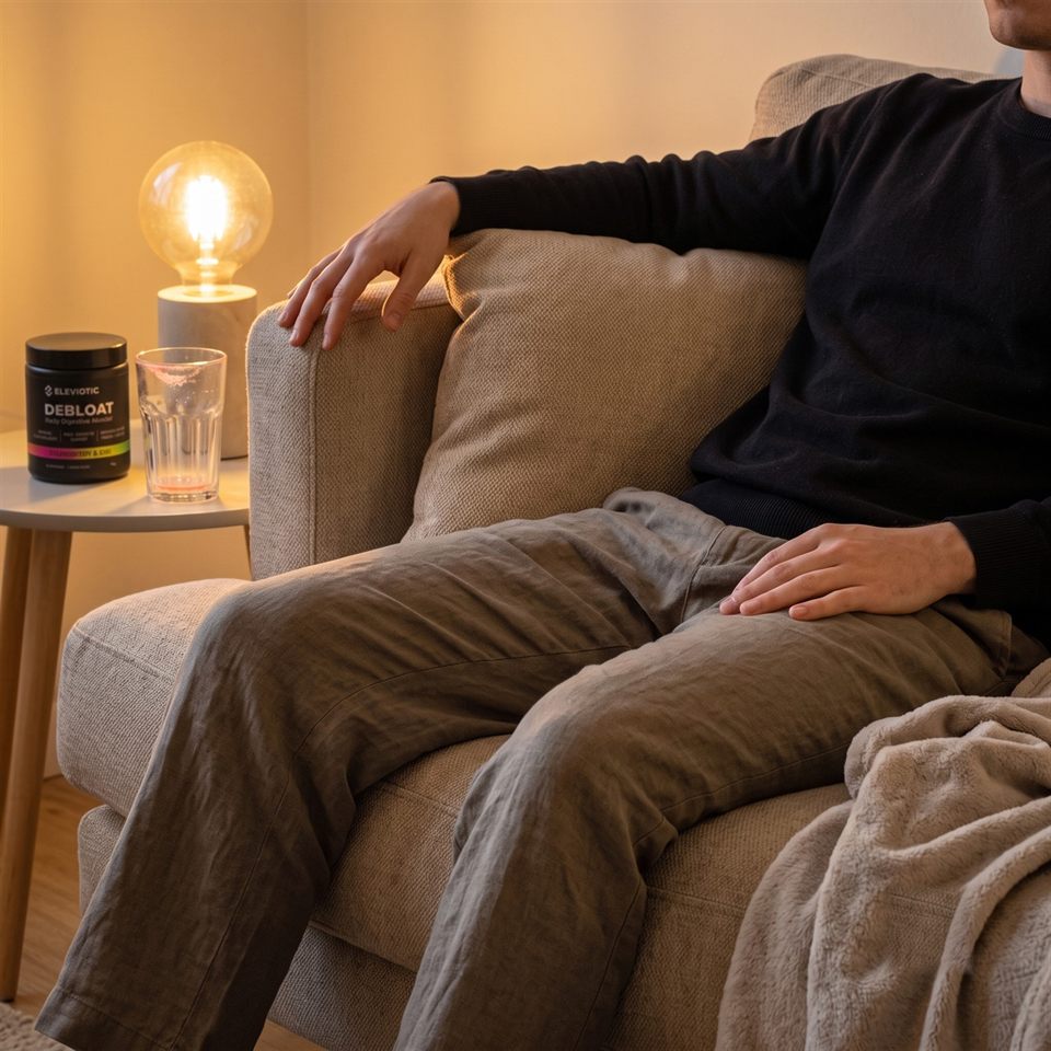 Sitting back comfortably on the sofa after a meal, a tub of Debloat on the side table